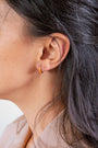 model wears Coral Gold Enamel Huggie Earrings