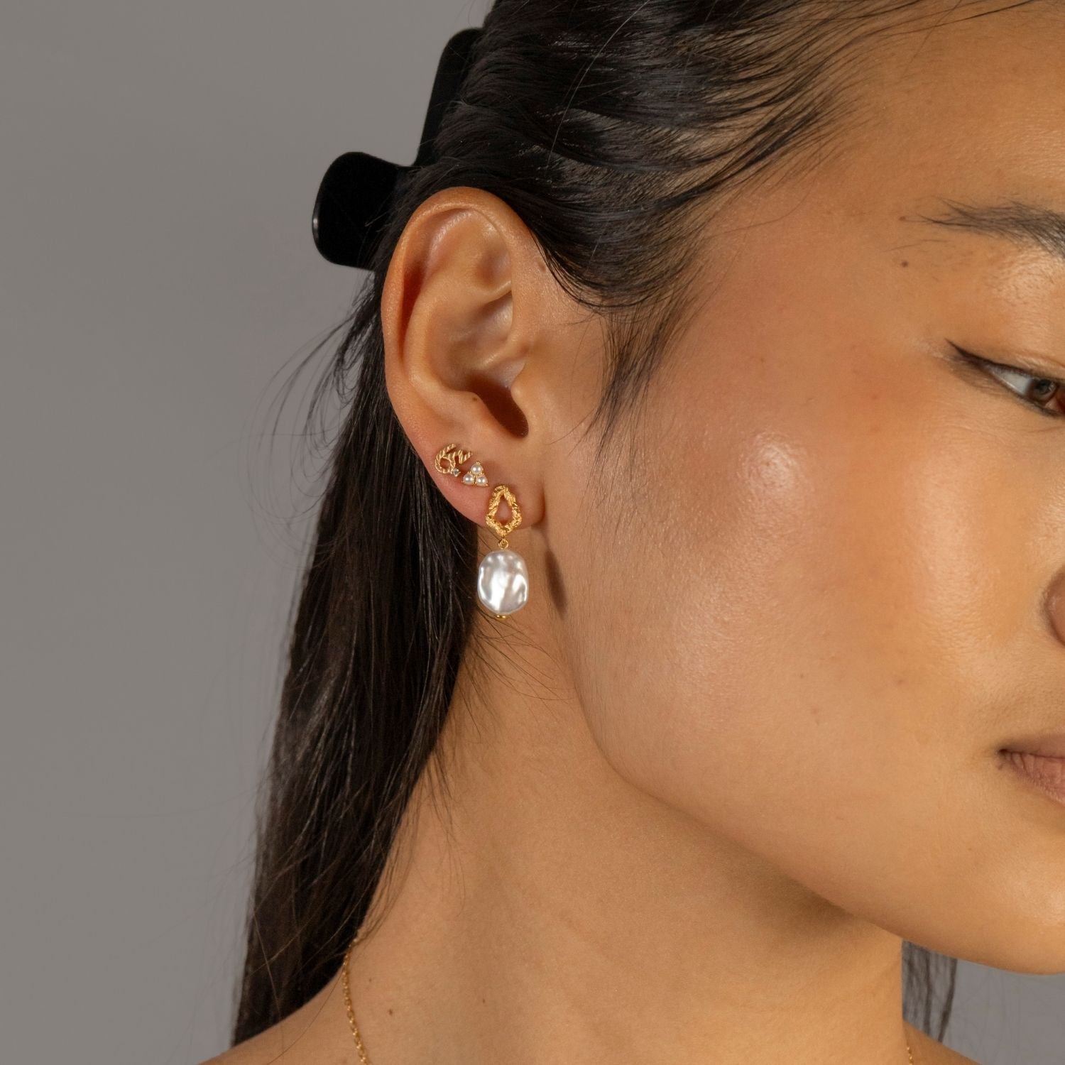 model wears Brave Gold Shorthand Stud Earring