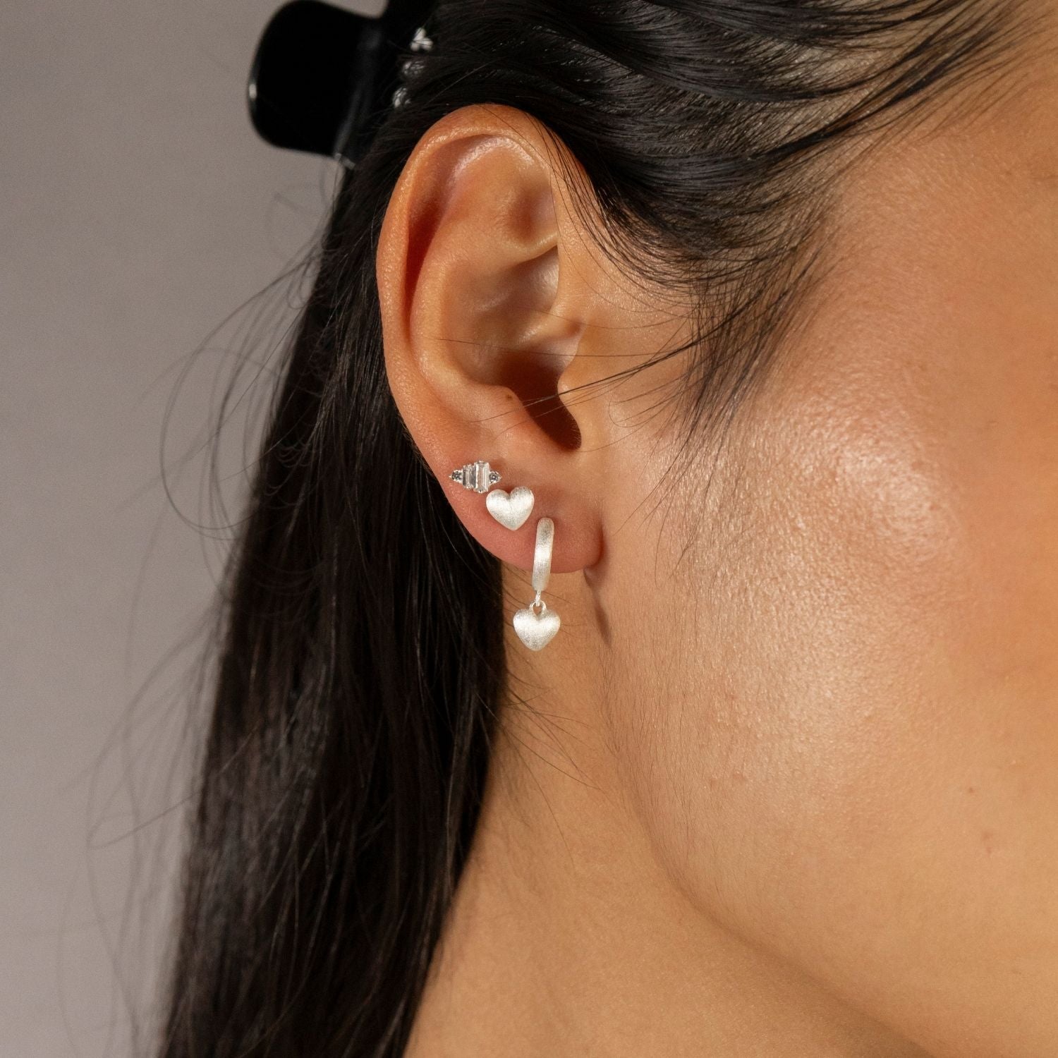 Jade wears Brushed Heart Silver Huggie Hoops