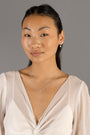 Jade wears Brushed Heart Silver Huggie Hoops