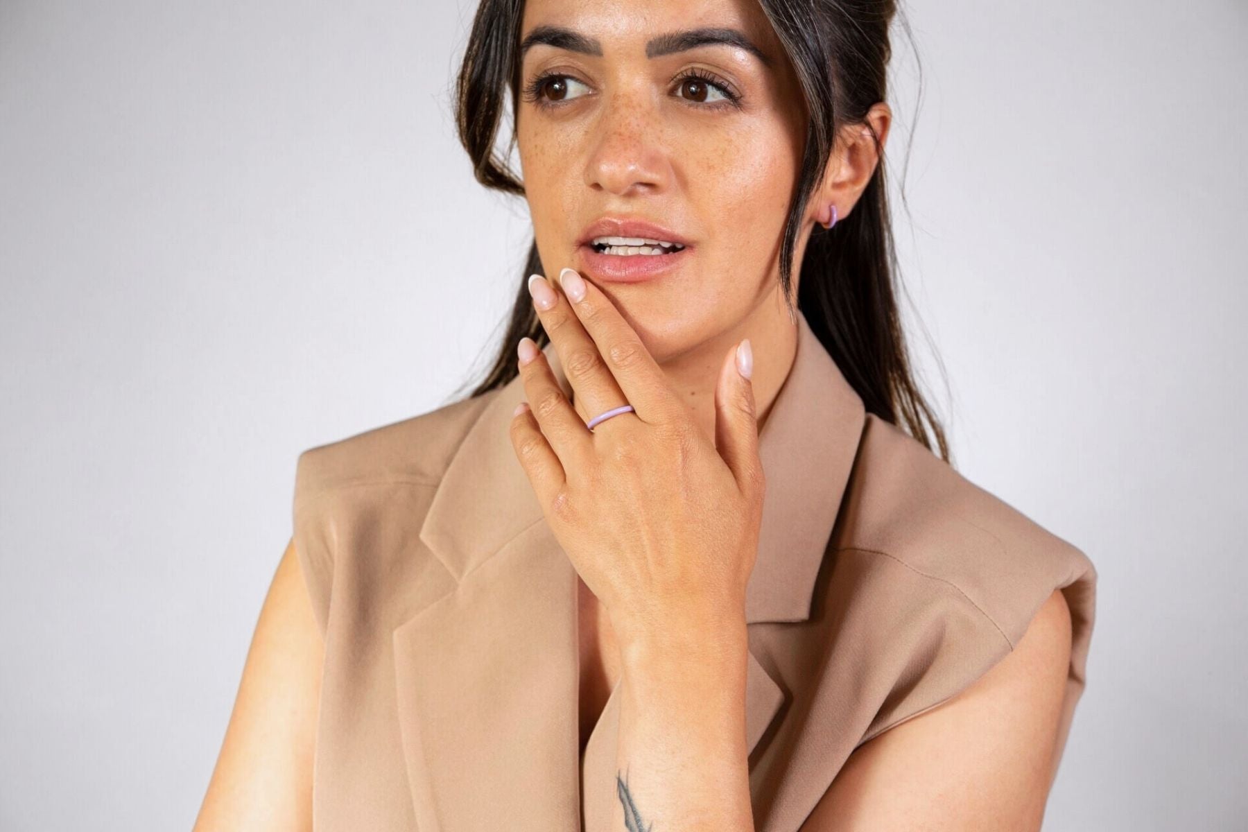 model wears lavender enamel earrings and lavender huggie hoop earrings 