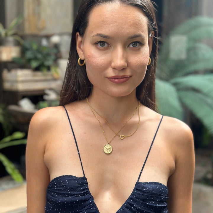 model wears “Fuck” Gold Shorthand Coin Necklace
