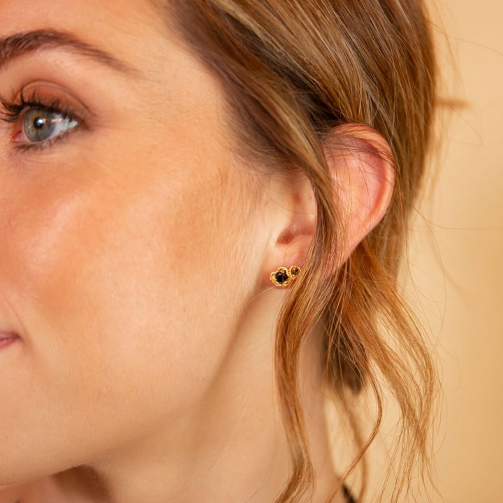 model wears 14k gold vermeil black spinel climber statement stud earrings