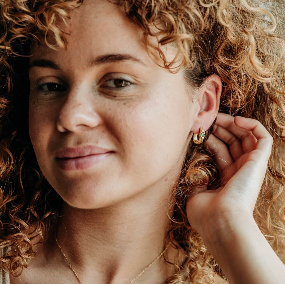 model wears Emerald and 14k gold vermeil branch statement hoop earrings