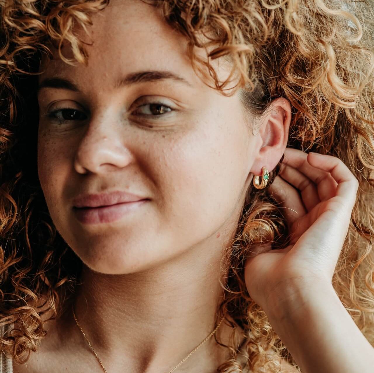 model wears Emerald and 14k gold vermeil branch statement hoop earrings
