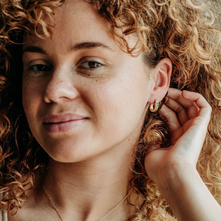 model wears Emerald and 14k gold vermeil branch statement hoop earrings