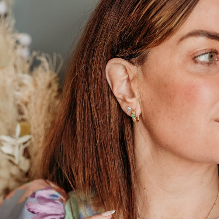 model wears Emerald and 14k gold vermeil branch statement hoop earrings