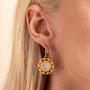 model wears Geometric Mother of Pearl and Gold Statement Hoop Earrings close up