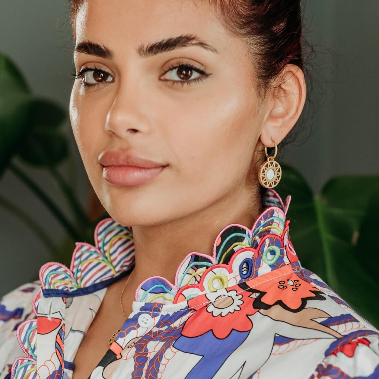model wears Geometric Mother of Pearl and Gold Statement Hoop Earrings