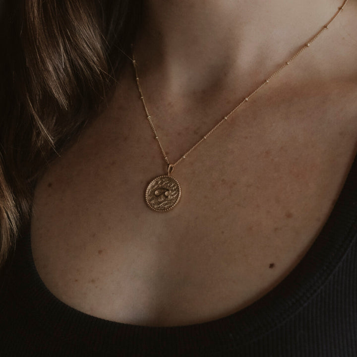 model wears “Fuck” Gold Shorthand Coin Necklace
