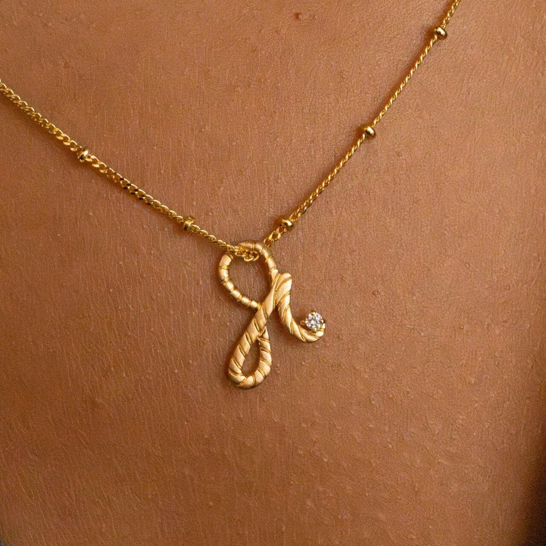 model wears 14k gold vermeil Shorthand charm necklace on satellite chain meaning Fearless -  Claire Hill Designs