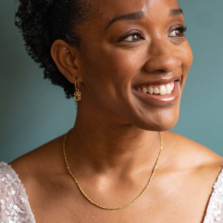 model wears Stardust Gold Layering Chain Necklace and sapphire hoop earrings