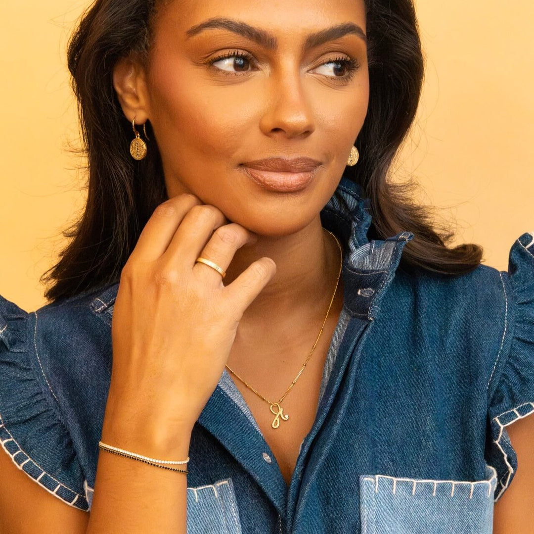 model wears 14k gold vermeil Shorthand charm necklace meaning Fearless on satellite beaded chain -  Claire Hill Designs