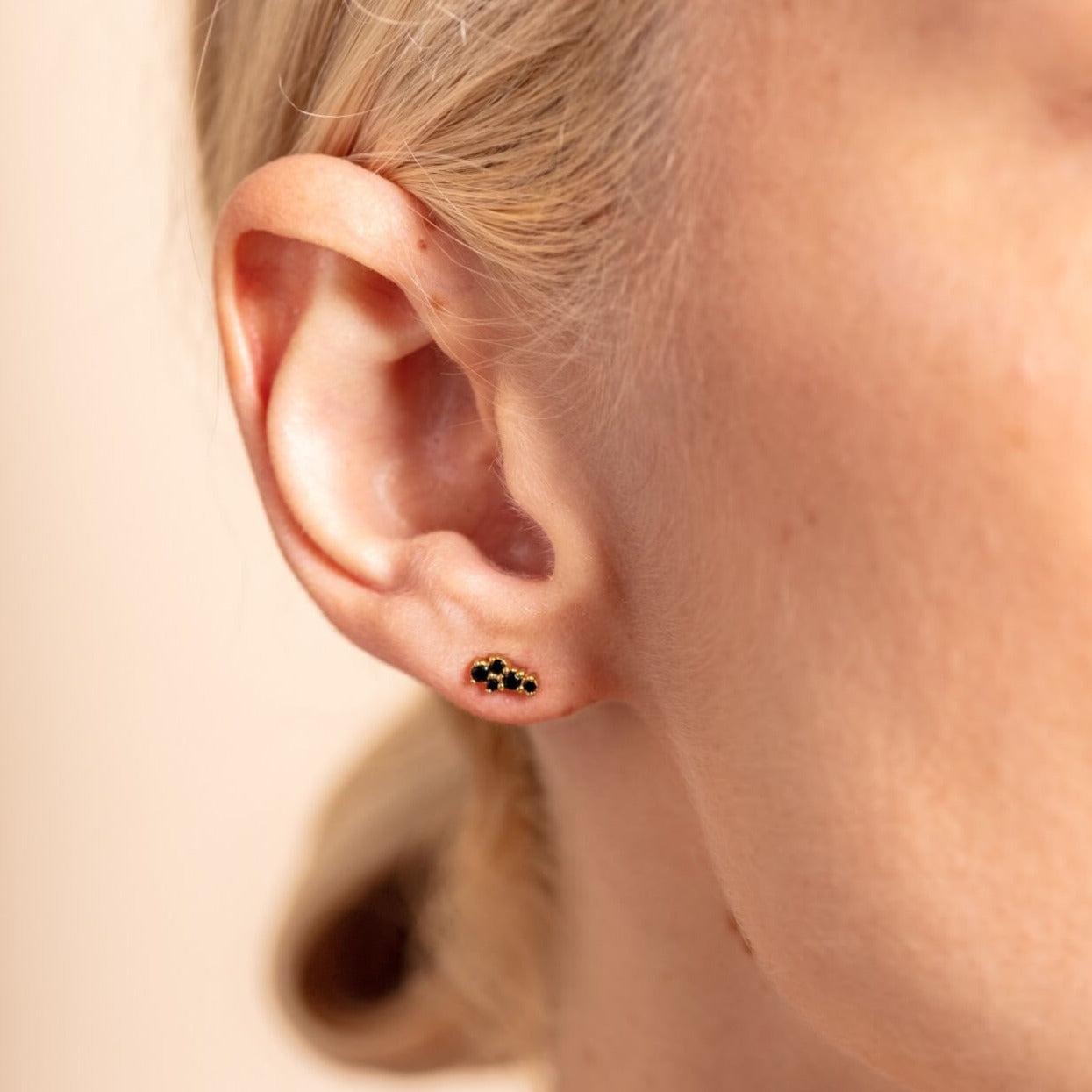 model wears 18k gold vermeil and black cubic zirconia mini stud earrings