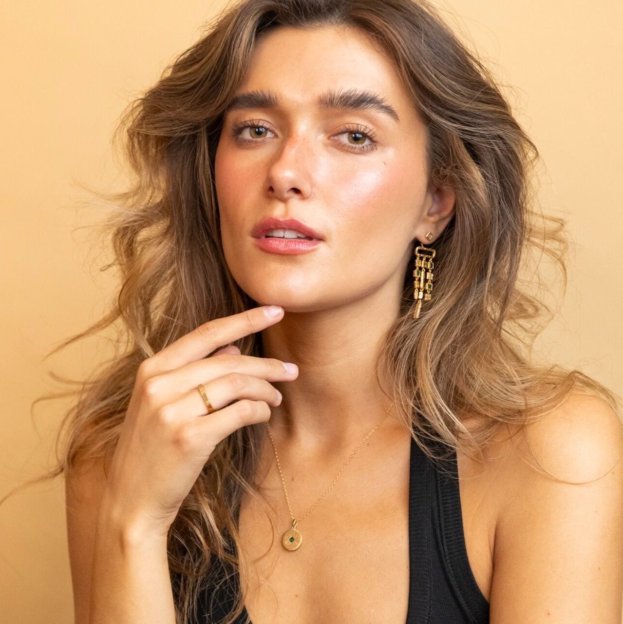 model wears Gold vermeil emerald asymetric statement ear jacket earrings