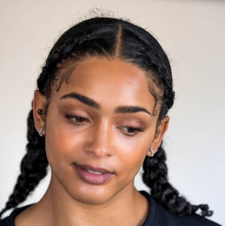 Model wears 18k gold vermeil turquoise scattered huggie hoop earrings