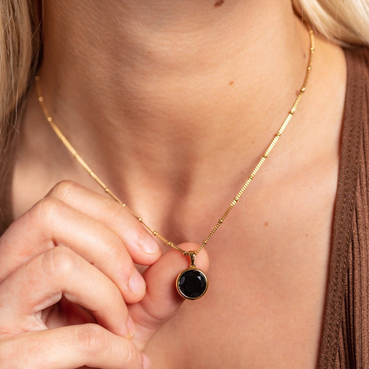 model wears 18k gold vermeil black onyx disc pendant necklace 