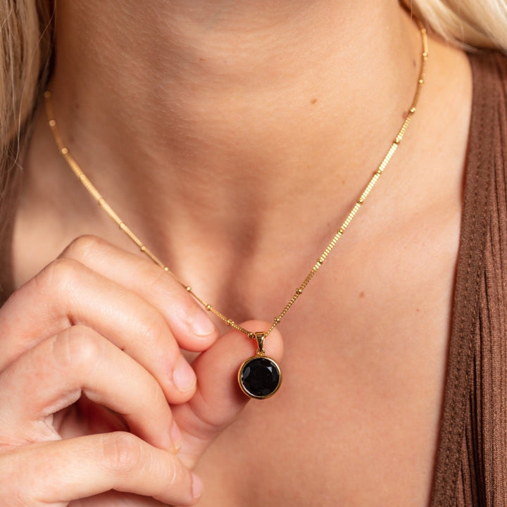 model wears 18k gold vermeil and black onyx gemstone disc necklace 
