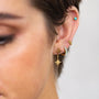 model wears brushed star gold earrings, opal huggie hoop earring and 18k gold vermeil and blue lab-grown opal stud earrings
