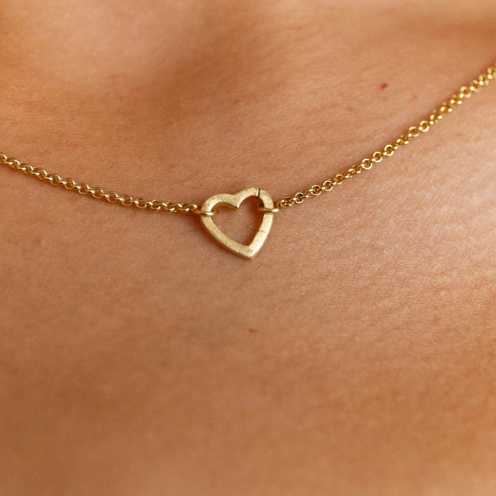 model wears 18k gold vermeil brushed heart connector necklace on rolo chain - Claire Hill Designs