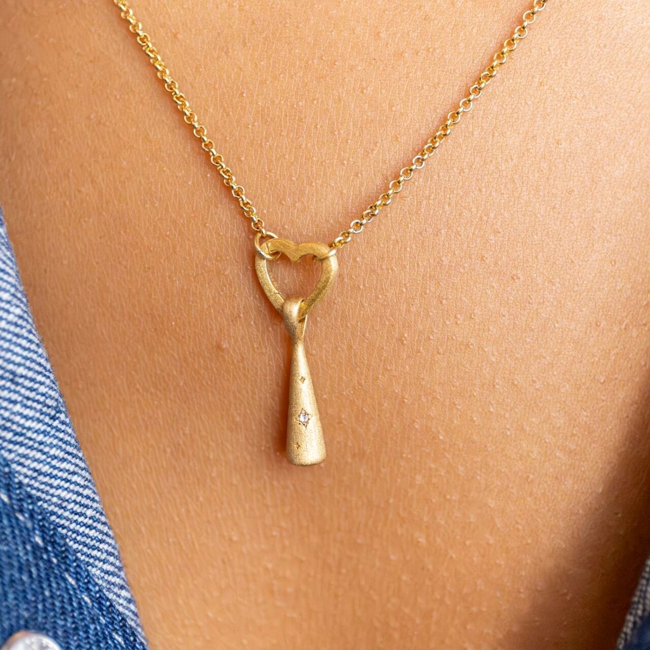 Model wears 18k Gold Vermeil Comet Charm Pendant hanging on Rolo Heart Connector necklace - Claire Hill Designs 