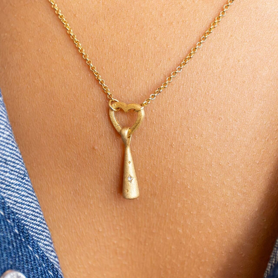 Model wears 18k Gold Vermeil Comet Charm Pendant hanging on Rolo Heart Connector necklace - Claire Hill Designs 