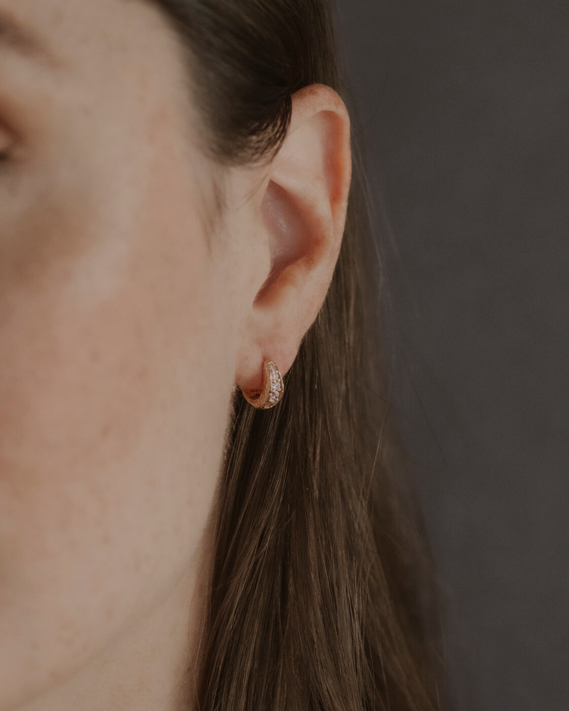 model wears Lab-grown diamond antique gold huggie hoops
