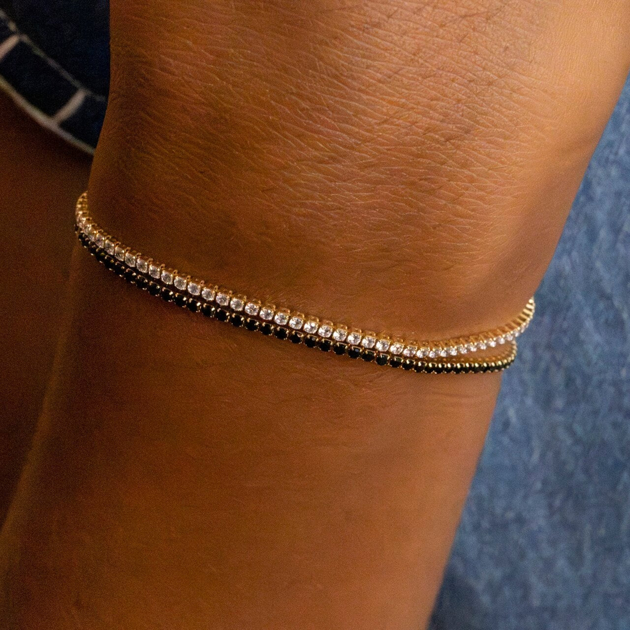 Model wears Black Cubic Zirconia Gold Tennis Bracelet