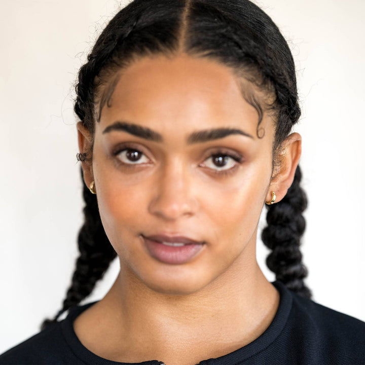 model wears Sparkly Star Gold Huggie Earrings