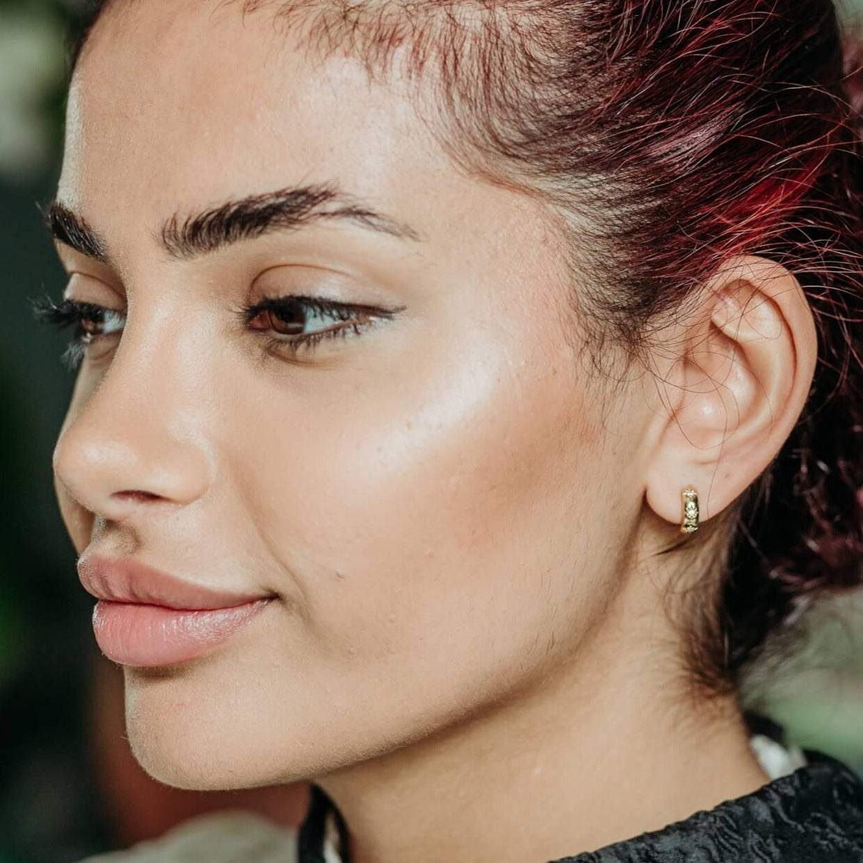 model wears Sparkly Star Gold Huggie hoop Earrings