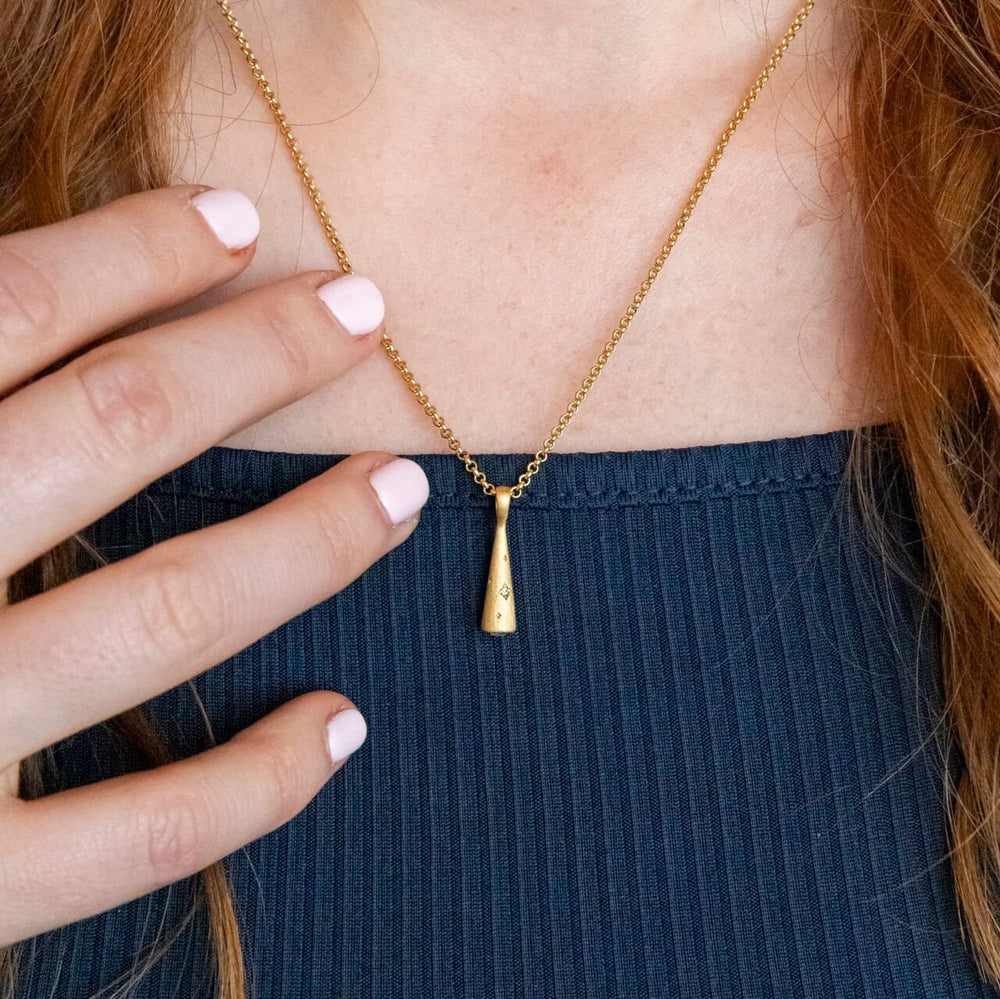Model wears 18k Gold Vermeil Comet Charm Pendant on  Rolo Heart Necklace - Claire Hill Designs