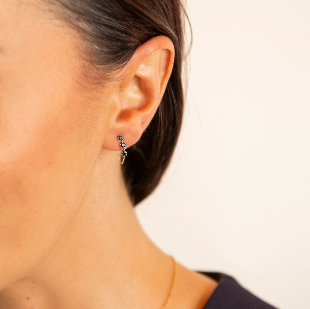 model wears 9ct solid gold and sapphire chain stud earrings