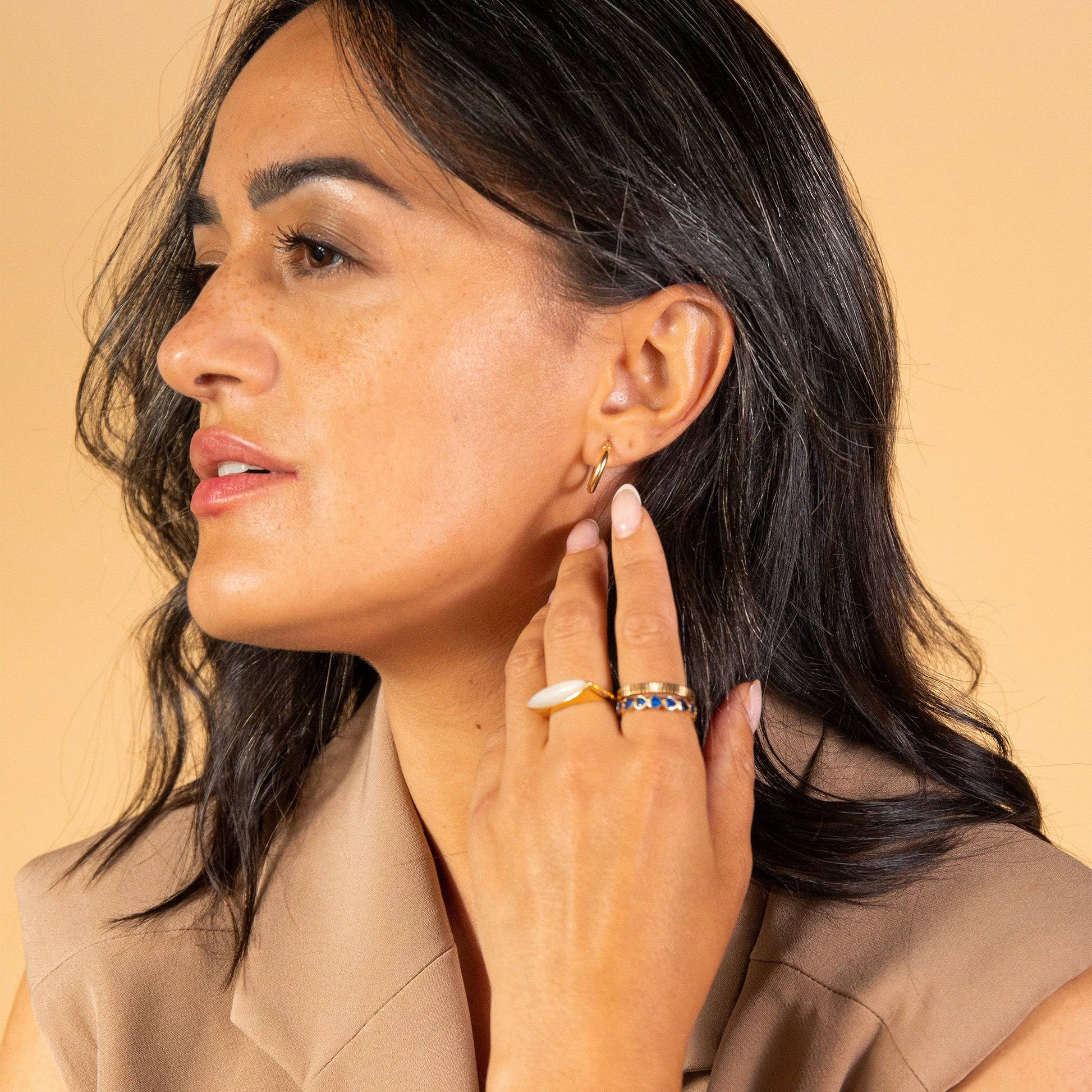 model wears 9ct Solid Gold Hoop Earrings (15mm)
