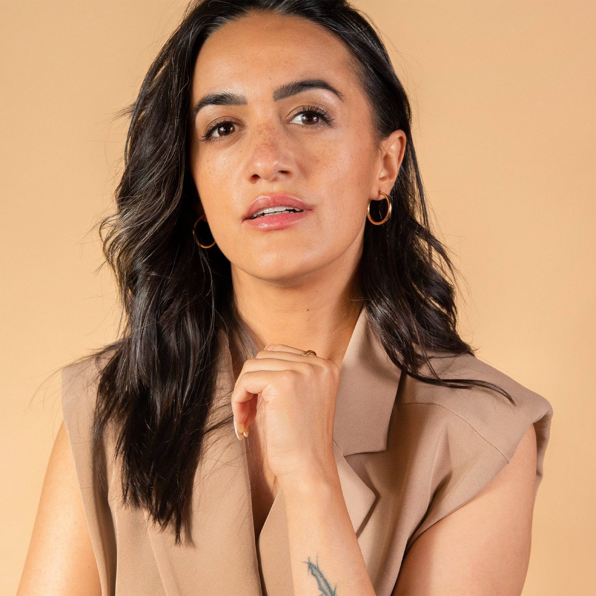 model wears Large 9ct Solid Gold Hoop Earrings (25mm)
