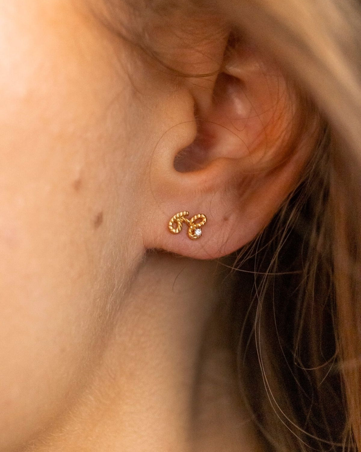 model wears Beautiful Gold Shorthand Stud Earring