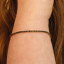 Model wears Black Cubic Zirconia Gold Tennis Bracelet