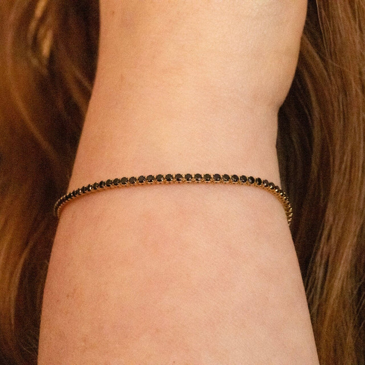 Model wears Black Cubic Zirconia Gold Tennis Bracelet