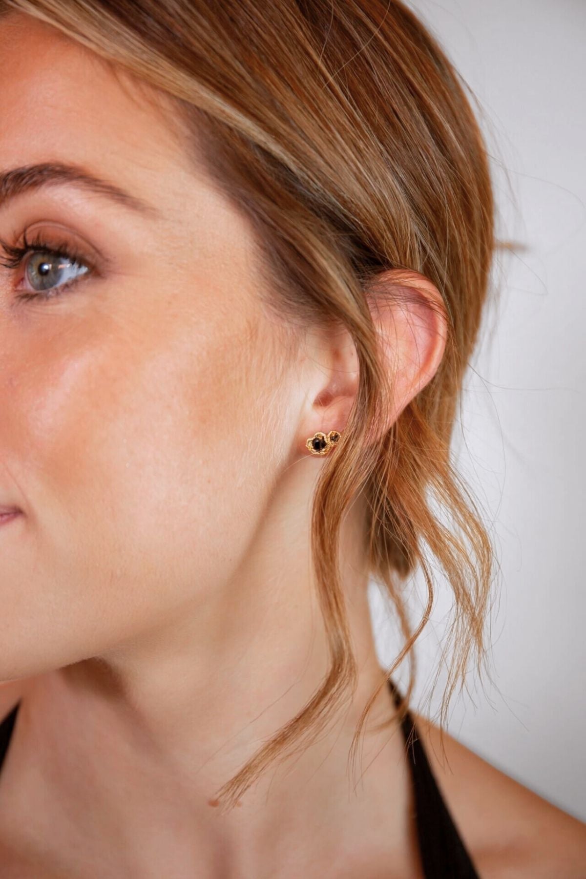 model wears black spinel lichen double gold climber stud earrings
