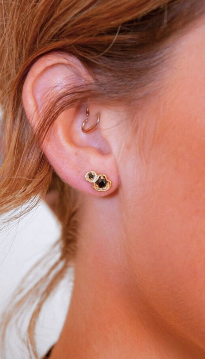 model wears black spinel lichen double gold climber stud earrings