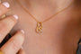 model wears Brave Gold Shorthand Charm Necklace