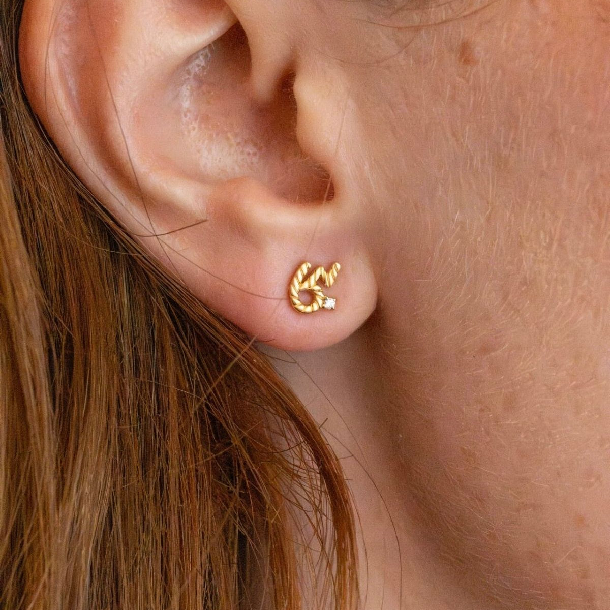 model wears Brave Gold Shorthand Stud Earring