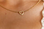 model wears brushed heart connector necklace close up