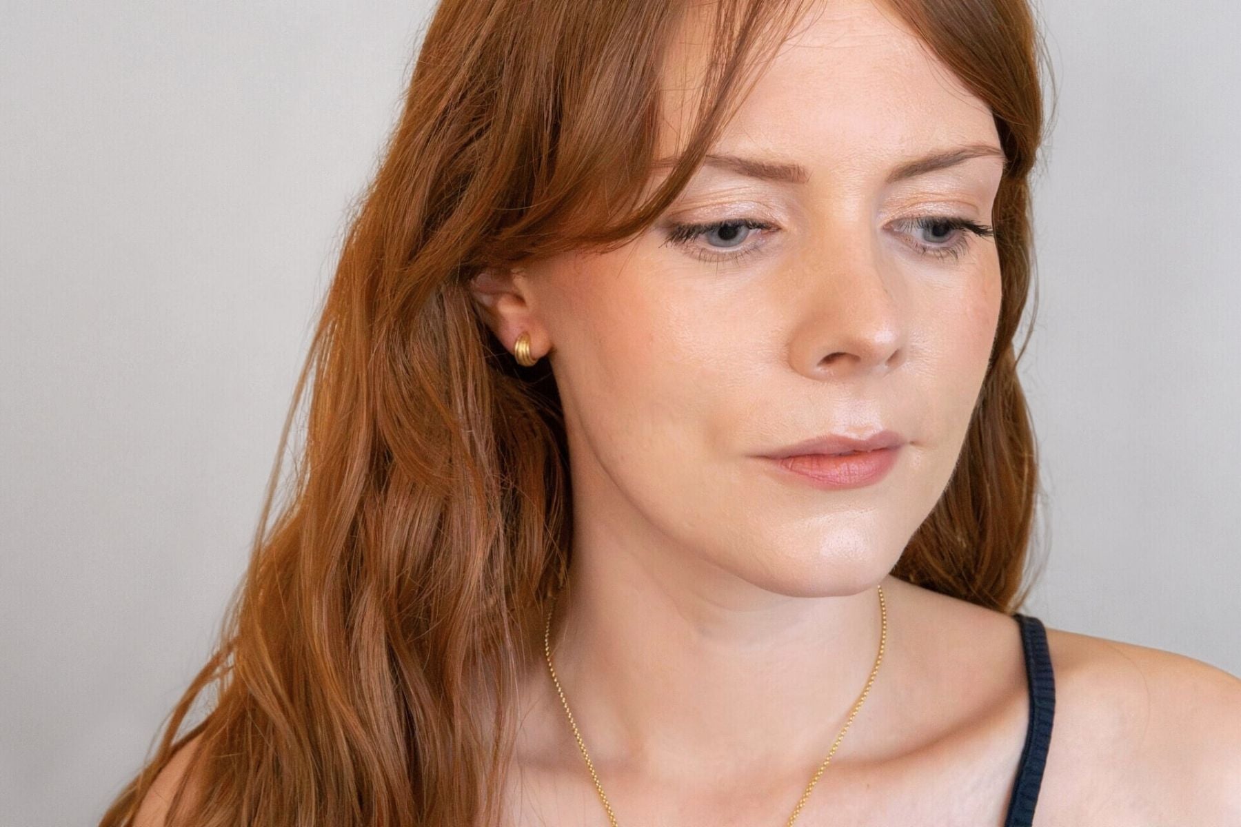 model wears Ridged Chunky Gold Huggie Hoops