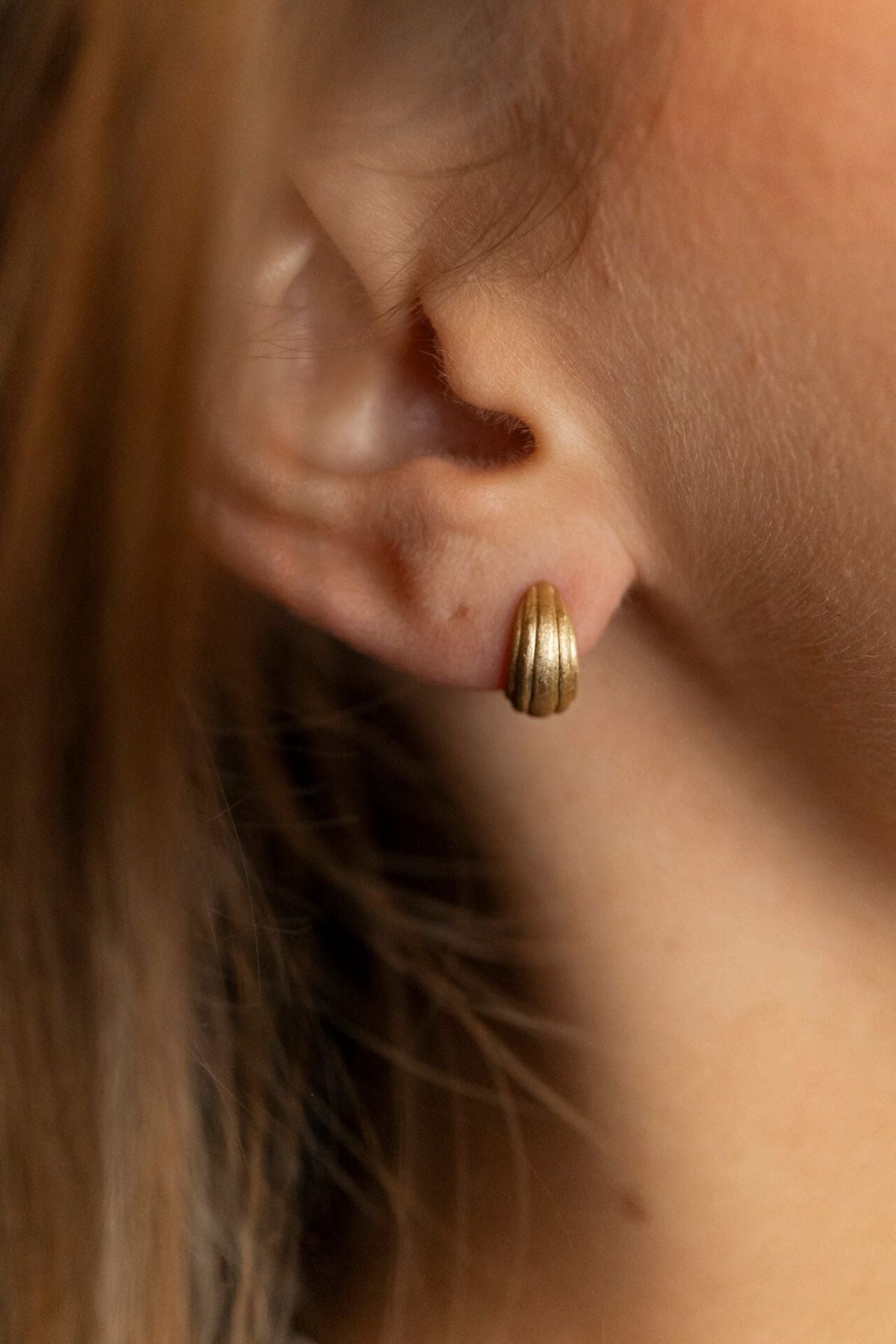 model wears Ridged Chunky Gold Huggie Hoops