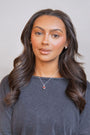 model wears Garnet Heart in Hand Silver Charm Necklace
