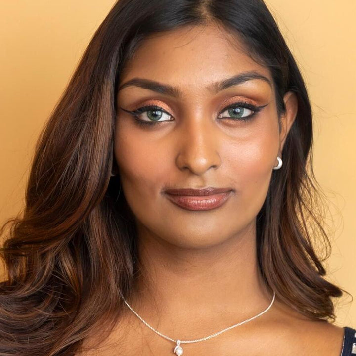 model wears chunky silver huggie hoop earrings