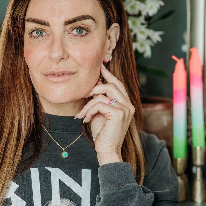 model wears Enamel Rings in Pink, Lavender and Turquoise