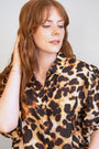 model wears Courage Gold Shorthand Charm Necklace