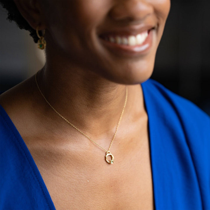 model wears Emerald and Gold Small Eternity Branch Circle Necklace 