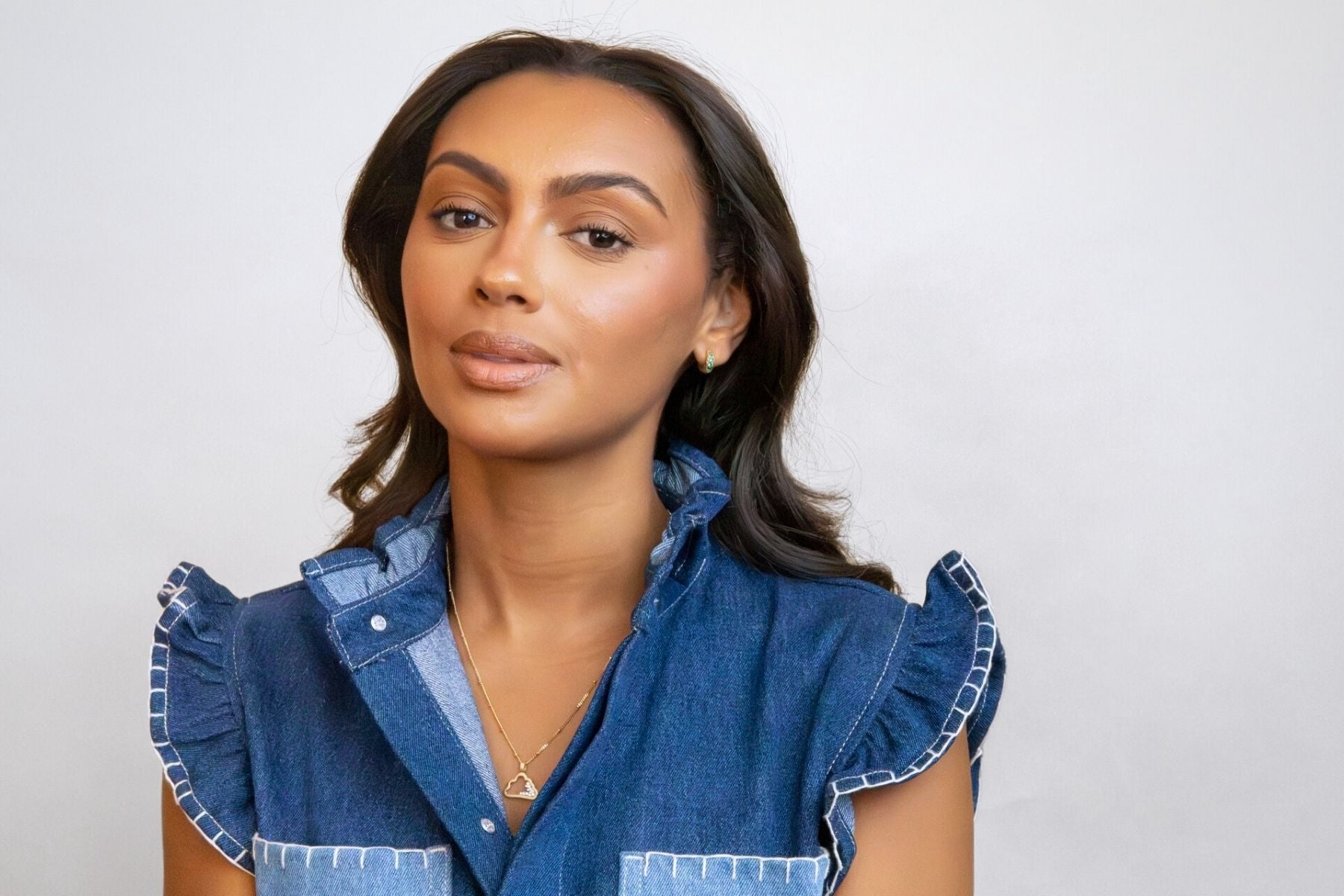 model wears emerald antique huggie hoop earrings